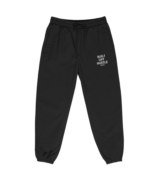 Blakk Apparel recycled tracksuit pants with 'Built Off Hustle' logo - black track pant featuring the phrase 'Built Off Hustle' in stylish white lettering, embodying the brand's ethos of hard work, determination, and success.