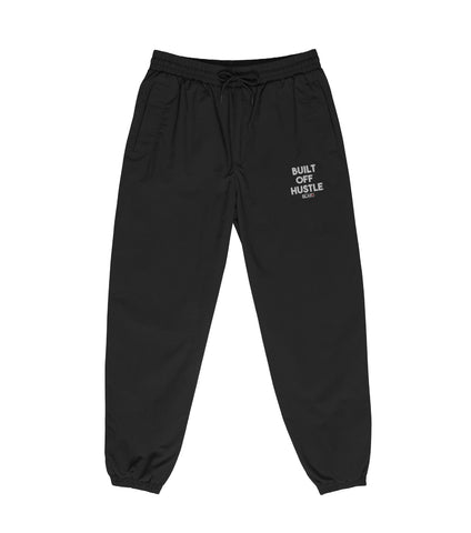 Blakk Apparel recycled tracksuit pants with 'Built Off Hustle' logo - black track pant featuring the phrase 'Built Off Hustle' in stylish white lettering, embodying the brand's ethos of hard work, determination, and success.