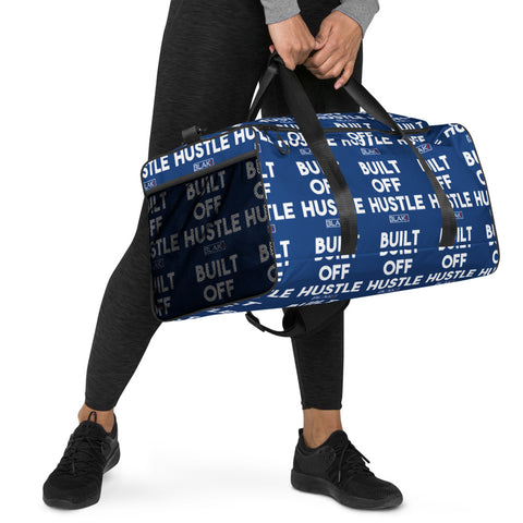 Blakk Apparel duffle bag with 'Built Off Hustle' logo - A blue duffle bag featuring the phrase 'Built Off Hustle' in stylish white lettering, embodying the brand's ethos of hard work, determination, and success.